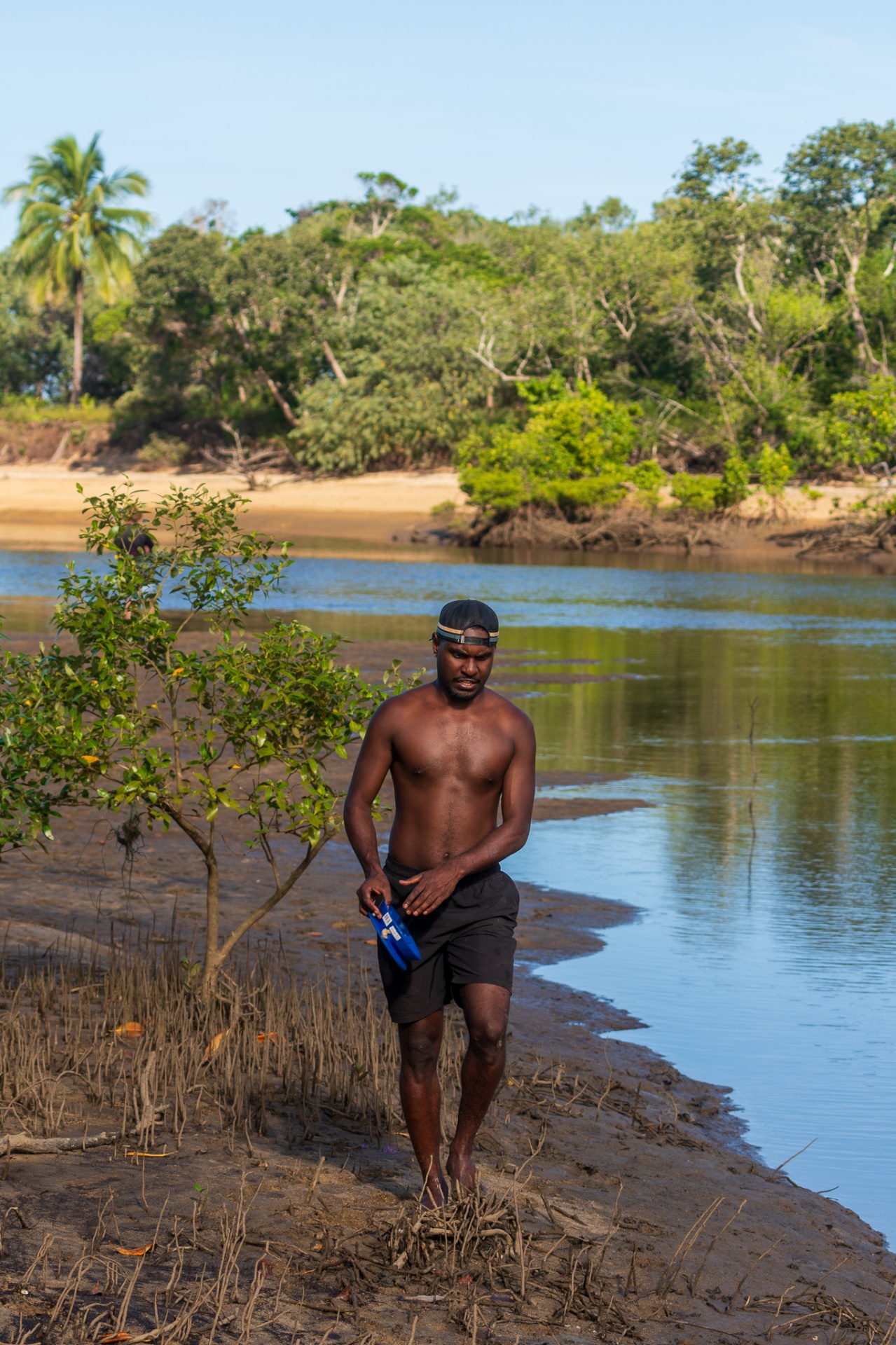 A brother walking through mangrove Country