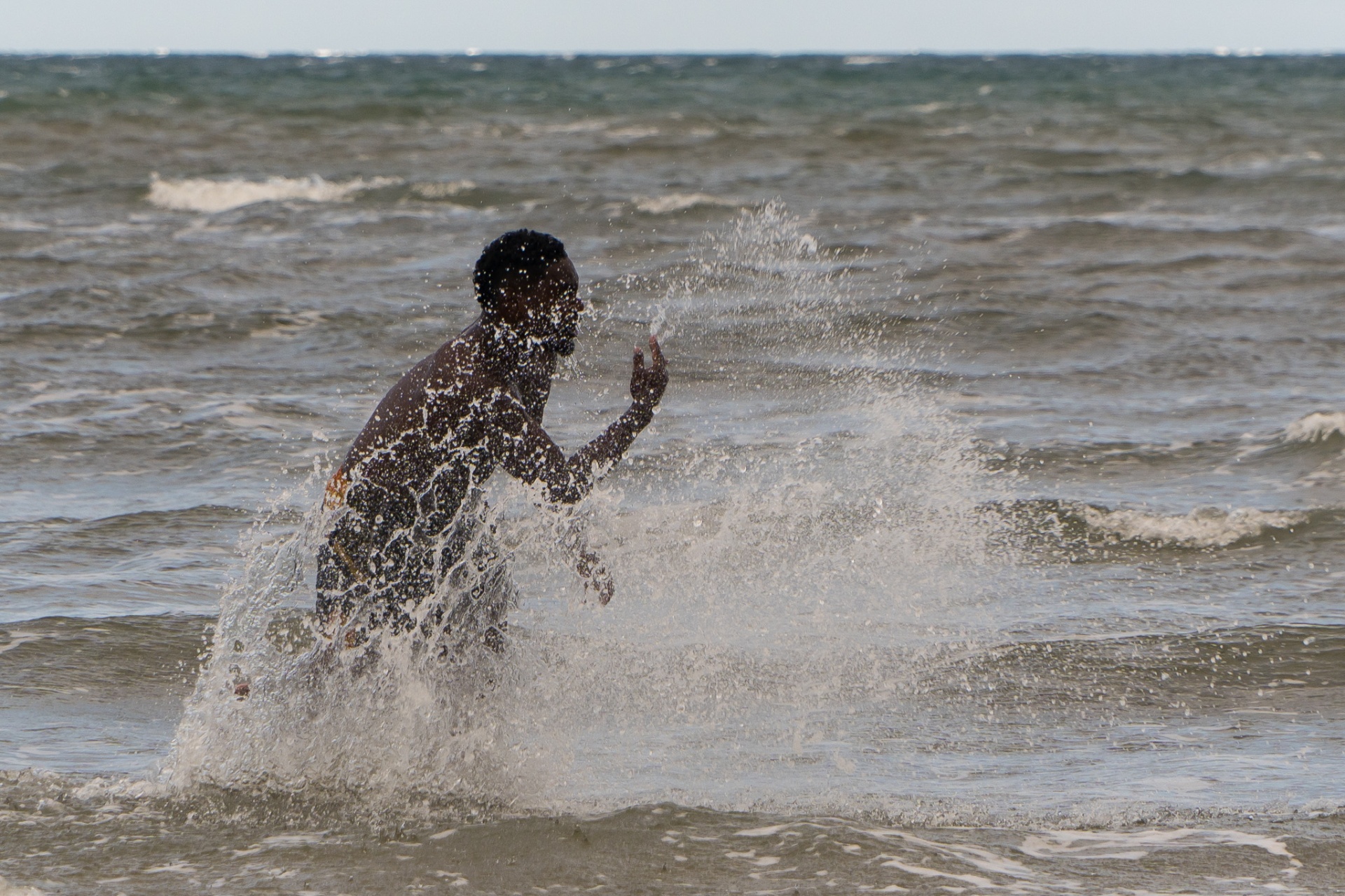 A brother running through the surf